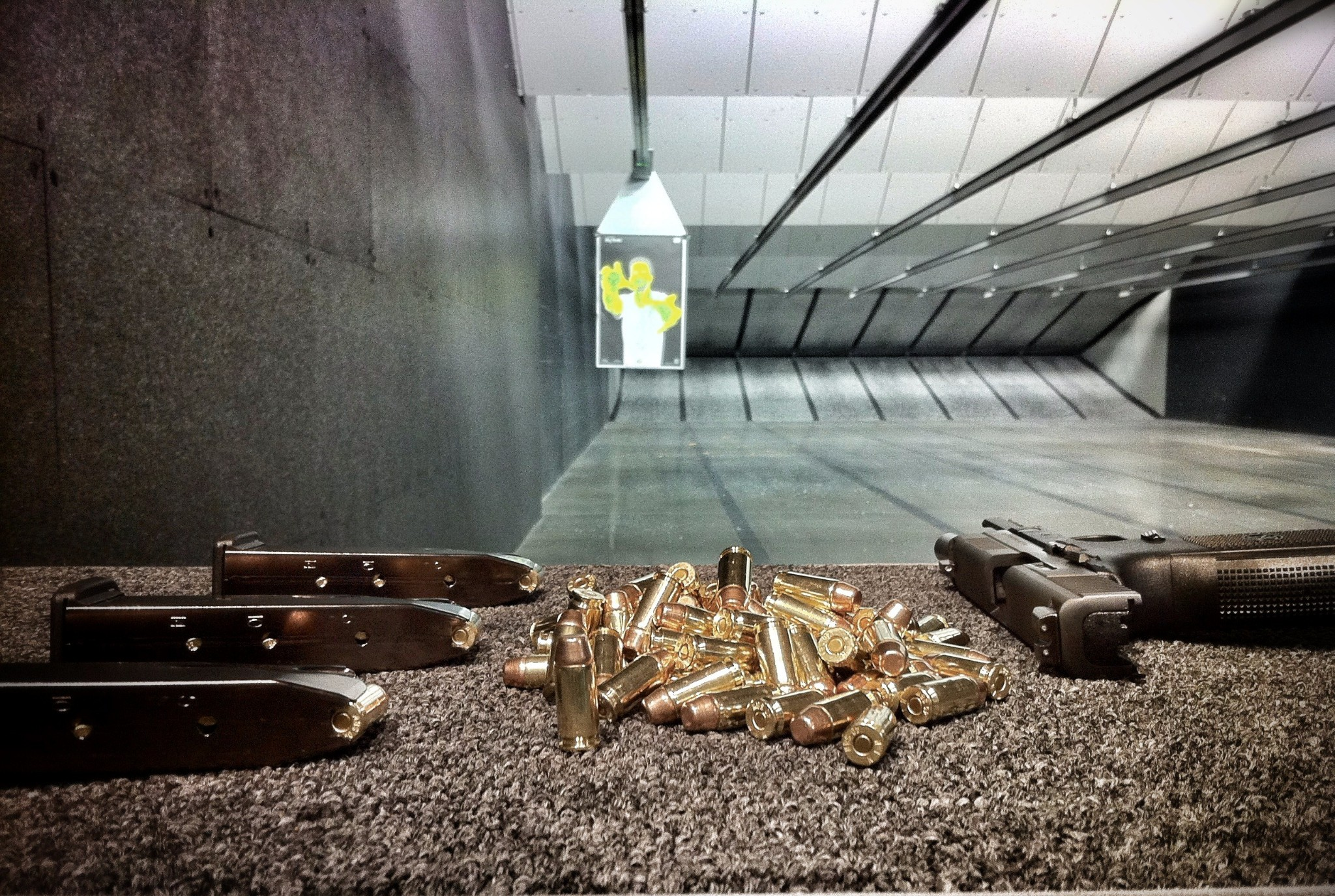 gun on range bench with downrange target